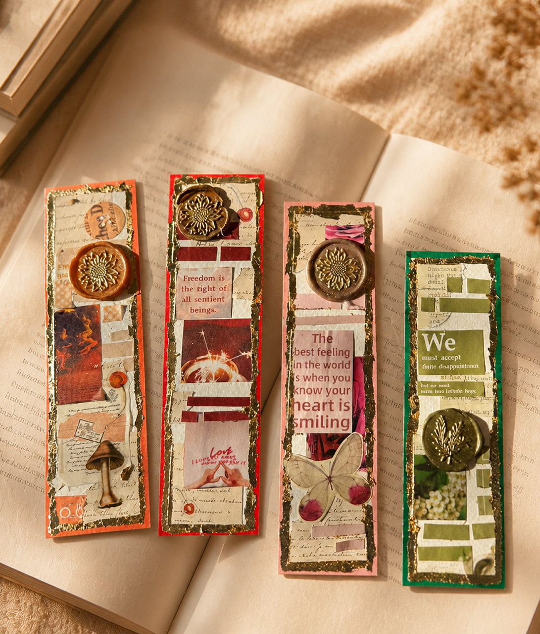 Four collaged bookmarks with wax seals, on an open book